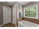 Bathroom features a soaking tub, large window, and a separate entrance door at 2530 Vistoria Dr, Cumming, GA 30041