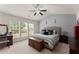 Bedroom with large windows, vaulted ceiling, ceiling fan, and neutral color palette at 2530 Vistoria Dr, Cumming, GA 30041