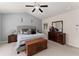 Neutral primary bedroom boasts a vaulted ceiling, ceiling fan, dresser and comfortable bed at 2530 Vistoria Dr, Cumming, GA 30041