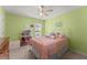 Cozy bedroom with a soft bed, natural lighting, carpet, and a ceiling fan at 2530 Vistoria Dr, Cumming, GA 30041