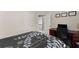 Cozy bedroom featuring a desk, chair, and view of the hallway, offering a functional and inviting space at 2530 Vistoria Dr, Cumming, GA 30041