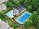 Aerial view of community pool, tennis court, parking, and greenery, offering resort-style living at 2530 Vistoria Dr, Cumming, GA 30041