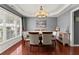 Elegant dining room featuring hardwood floors, large window, and a stylish chandelier at 2530 Vistoria Dr, Cumming, GA 30041