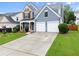 Beautiful two-story home with a well-maintained lawn, a two-car garage, and an inviting entrance at 2530 Vistoria Dr, Cumming, GA 30041