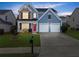 Charming two-story home featuring a red front door, two-car garage, and well-manicured lawn at 2530 Vistoria Dr, Cumming, GA 30041
