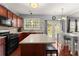 Eat-in kitchen with stainless steel appliances, stone countertops, a kitchen island, and backyard access at 2530 Vistoria Dr, Cumming, GA 30041