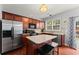 Modern kitchen with stainless steel appliances, center island with seating, and ample cabinet space at 2530 Vistoria Dr, Cumming, GA 30041