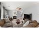Living room with comfortable sofas, fireplace, ceiling fan, and stairs at 2530 Vistoria Dr, Cumming, GA 30041