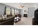 Living room featuring a fireplace, fan, and a comfortable seating area with natural light at 2530 Vistoria Dr, Cumming, GA 30041