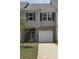 Charming two-story townhouse with a brick facade, attached garage and well-maintained lawn at 2804 Lillian Ln, Douglasville, GA 30135