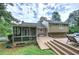 Backyard showcasing a screened-in porch, wooden deck, and lush greenery at 123 Mill Ln, Dallas, GA 30157