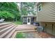 Backyard featuring a spacious wooden deck, screened-in porch, and mature trees at 123 Mill Ln, Dallas, GA 30157