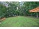 Large backyard featuring a level lot, mature trees, fire pit, and plenty of room for activities at 123 Mill Ln, Dallas, GA 30157