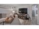 Finished basement living space features a large sofa, wood floors, a tv, and neutral walls at 123 Mill Ln, Dallas, GA 30157