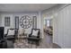 This finished basement has wood floors, neutral walls, and a living space with black chairs at 123 Mill Ln, Dallas, GA 30157
