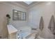 Bathroom soaking tub features a skylight, decoratives, and a tile floor at 123 Mill Ln, Dallas, GA 30157