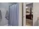 Bathroom shower with a cloth curtain, plus a view into the primary bedroom at 123 Mill Ln, Dallas, GA 30157