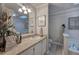 Bathroom vanity featuring a skylight, a large mirror and plenty of decorations at 123 Mill Ln, Dallas, GA 30157