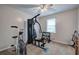 Spacious bedroom featuring a modern ceiling fan and small exercise equipment in the corner at 123 Mill Ln, Dallas, GA 30157