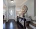 Elegant foyer with dark hardwood floors, stylish console table, and a large decorative clock at 123 Mill Ln, Dallas, GA 30157