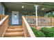 Inviting front porch with new wood stairs, white railing, and seating area at 123 Mill Ln, Dallas, GA 30157