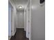 Clean, neutrally painted hallway with multiple doors and dark laminate floors at 123 Mill Ln, Dallas, GA 30157