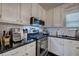 Updated kitchen with stainless steel appliances, granite countertops, and stylish tile backsplash at 123 Mill Ln, Dallas, GA 30157