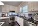 Modern kitchen featuring stainless steel appliances, granite countertops, and white cabinets at 123 Mill Ln, Dallas, GA 30157