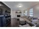 Comfortable living room featuring a stone fireplace, large sectional sofa, and hardwood floors at 123 Mill Ln, Dallas, GA 30157
