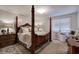 Primary bedroom features a canopy bed, hardwood floors, and natural light at 123 Mill Ln, Dallas, GA 30157