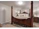 Primary bedroom features a canopy bed, hardwood floors, and two night stands at 123 Mill Ln, Dallas, GA 30157