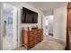 Primary bedroom features a large television, dresser, and an ensuite bath at 123 Mill Ln, Dallas, GA 30157