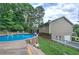 Backyard with a refreshing pool, wooden deck, and convenient access to the house and garage at 123 Mill Ln, Dallas, GA 30157