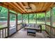 Relax in this screened porch with a wood ceiling, ceiling fan, and a view of the backyard at 123 Mill Ln, Dallas, GA 30157