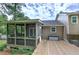 Backyard view of a screened-in porch with a wooden deck and cozy outdoor furniture at 123 Mill Ln, Dallas, GA 30157