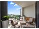 Condo balcony with upscale outdoor seating, planters and city views at 2425 Peachtree Ne Rd # 1503, Atlanta, GA 30305