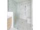 This bathroom has white marble tile and a glass door shower at 2425 Peachtree Ne Rd # 1503, Atlanta, GA 30305