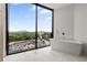Bright bathroom features city views from a modern tub near a large window at 2425 Peachtree Ne Rd # 1503, Atlanta, GA 30305