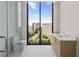 This modern bathroom features light-colored wood vanities and a walk-in shower with great views at 2425 Peachtree Ne Rd # 1503, Atlanta, GA 30305