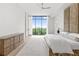 Modern bedroom with hardwood floors, ceiling fan, and large windows displaying a beautiful skyline at 2425 Peachtree Ne Rd # 1503, Atlanta, GA 30305