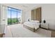 This bedroom features a neutral color palette and a large window showcasing the city skyline at 2425 Peachtree Ne Rd # 1503, Atlanta, GA 30305