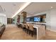 Resident lounge with comfortable seating, a large bar, and herringbone floors at 2425 Peachtree Ne Rd # 1503, Atlanta, GA 30305
