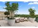 Relaxing rooftop patio featuring upscale outdoor seating, greenery, and a stunning skyline view at 2425 Peachtree Ne Rd # 1503, Atlanta, GA 30305