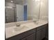 Bright bathroom featuring a double sink vanity with modern fixtures and a large mirror at 2812 Lillian Ln, Douglasville, GA 30135