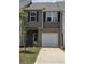 Two story townhome with brick facade and attached one car garage at 2812 Lillian Ln, Douglasville, GA 30135