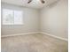 This bedroom has carpet, a ceiling fan, and a window that provides natural light at 3312 Northcrest Rd # A, Atlanta, GA 30340