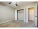 A bright carpeted bedroom offers a ceiling fan, an open closet, and an open door with access to the hallway at 3312 Northcrest Rd # A, Atlanta, GA 30340