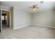 This brightly lit bedroom has carpet, a ceiling fan, and an open door at 3312 Northcrest Rd # A, Atlanta, GA 30340
