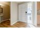 Bright entryway featuring hardwood floors, neutral walls, a white front door, and a half bath with a pedestal sink at 3312 Northcrest Rd # A, Atlanta, GA 30340