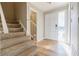 Inviting entryway with a staircase, neutral paint, and a white front door with glass sidelight providing plenty of natural light at 3312 Northcrest Rd # A, Atlanta, GA 30340